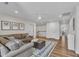 Spacious living room features a sectional sofa, soft rug, and plenty of natural light at 3181 Zebroid Way, New Hill, NC 27562
