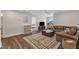 Open living room with hardwood floors, plush leather sofa, and neutral-toned decor at 3181 Zebroid Way, New Hill, NC 27562
