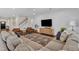 Spacious living room with hardwood floors, ceiling fan and staircase to the left at 3181 Zebroid Way, New Hill, NC 27562