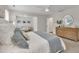 Serene main bedroom boasts neutral tones, an ensuite, and a cozy sitting area at 3181 Zebroid Way, New Hill, NC 27562