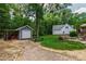 Spacious backyard with a shed, stone firepit and deck, ideal for outdoor gatherings at 3304 Buck Run Trl, Wake Forest, NC 27587