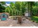 Charming backyard with a stone fire pit and playhouse at 3304 Buck Run Trl, Wake Forest, NC 27587