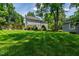 Expansive backyard featuring a lush lawn, patio, and mature trees, offering privacy and space for outdoor activities at 3304 Buck Run Trl, Wake Forest, NC 27587