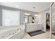 Bright bathroom with double sinks, a soaking tub, and a large mirror for lots of light at 3304 Buck Run Trl, Wake Forest, NC 27587