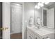 Clean bathroom with a white vanity, sink, and mirror, plus access to hallway at 3304 Buck Run Trl, Wake Forest, NC 27587