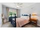 Charming bedroom with a blue four-poster bed, dresser, and plenty of natural light at 3304 Buck Run Trl, Wake Forest, NC 27587