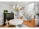 Bright dining room with a round table, hardwood floors, and a stylish light fixture at 3304 Buck Run Trl, Wake Forest, NC 27587