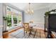 Sunlit dining area with a round table, hardwood floors, and a large window view at 3304 Buck Run Trl, Wake Forest, NC 27587