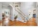 Open foyer with hardwood floors, staircase, and views to the living room and dining room at 3304 Buck Run Trl, Wake Forest, NC 27587