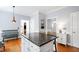 Spacious kitchen island with granite countertops, wooden bar stools, and white cabinets at 3304 Buck Run Trl, Wake Forest, NC 27587