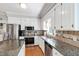 Well-lit kitchen with stainless steel appliances, granite counters, and hardwood flooring at 3304 Buck Run Trl, Wake Forest, NC 27587