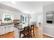 Bright, open kitchen with an island, bar stools, granite countertops, and white cabinetry at 3304 Buck Run Trl, Wake Forest, NC 27587
