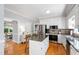 Charming kitchen with granite counters, island, stainless steel appliances and hardwood flooring at 3304 Buck Run Trl, Wake Forest, NC 27587