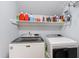 Modern laundry room with a washer, dryer, and storage shelves for supplies at 3304 Buck Run Trl, Wake Forest, NC 27587