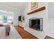 Inviting living room with painted brick fireplace, wood mantle, and beautiful hardwood floors at 3304 Buck Run Trl, Wake Forest, NC 27587