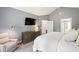 Neutral main bedroom with gray walls, a queen-size bed, a dresser, and an accent chair at 3304 Buck Run Trl, Wake Forest, NC 27587