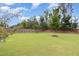 Spacious, well-maintained backyard with lush green grass, mature trees, and a privacy fence at 3361 Bordwell Ridge Dr. Dr, New Hill, NC 27562