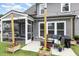 Cozy backyard patio with comfortable seating, string lights, and a screened-in porch, perfect for outdoor relaxation at 3361 Bordwell Ridge Dr. Dr, New Hill, NC 27562