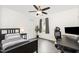 Bedroom with gray wood floors, ceiling fan, black furniture and large window at 3361 Bordwell Ridge Dr. Dr, New Hill, NC 27562