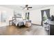 Spacious bedroom with a modern bed frame, wood flooring, and an office space at 3361 Bordwell Ridge Dr. Dr, New Hill, NC 27562