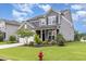 Charming two-story home with a manicured lawn, beautiful landscaping, and a welcoming front porch at 3361 Bordwell Ridge Dr. Dr, New Hill, NC 27562
