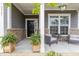 Inviting front porch with stone accents, seating area, and decorative plants for a cozy welcome at 3361 Bordwell Ridge Dr. Dr, New Hill, NC 27562