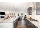 Modern kitchen with stainless steel appliances, granite countertops, and open layout flowing to living areas at 3361 Bordwell Ridge Dr. Dr, New Hill, NC 27562