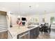 Open-concept kitchen with granite countertops, stainless steel appliances, and seamless flow to living area at 3361 Bordwell Ridge Dr. Dr, New Hill, NC 27562