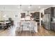 A modern kitchen with an island, bar stools, stainless steel appliances, and wood flooring at 3361 Bordwell Ridge Dr. Dr, New Hill, NC 27562