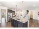 Beautiful kitchen featuring an island with granite countertops, a stainless steel refrigerator, and wood flooring at 3361 Bordwell Ridge Dr. Dr, New Hill, NC 27562