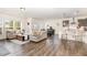 Open-concept living space featuring a large sectional sofa, dining area, and kitchen with island at 3361 Bordwell Ridge Dr. Dr, New Hill, NC 27562