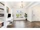 Bright office with a large window, built-in bookshelves, and stylish desk with dark hardwood floors at 3361 Bordwell Ridge Dr. Dr, New Hill, NC 27562