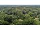 An aerial view showing the tree coverage and seclusion of the property at 3600 Trail 23 St, Durham, NC 27707