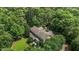 Aerial view of estate with a wooded lot, mature trees, and long driveway at 3600 Trail 23 St, Durham, NC 27707