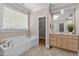Bathroom featuring a soaking tub, window, tile floor, and vanity with stone countertops at 3600 Trail 23 St, Durham, NC 27707
