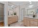Bathroom with double sink vanity, stone countertops and a door leading to a closet at 3600 Trail 23 St, Durham, NC 27707