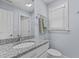 Bathroom features granite countertop, single sink vanity, and window at 3600 Trail 23 St, Durham, NC 27707