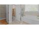Bathroom featuring a soaking tub, tile floor and entrance to a separate water closet at 3600 Trail 23 St, Durham, NC 27707