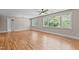 Spacious bedroom with hardwood floors, ceiling fan, and natural light from large windows at 3600 Trail 23 St, Durham, NC 27707