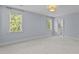 Blue bedroom with carpet, two windows, ceiling light and ensuite bath at 3600 Trail 23 St, Durham, NC 27707