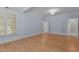 Bedroom with hardwood floors, a chandelier, and view into the attached bathroom at 3600 Trail 23 St, Durham, NC 27707