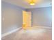 Bright bedroom with neutral paint, plush carpeting, and several doorways at 3600 Trail 23 St, Durham, NC 27707