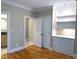 Cozy bedroom with wood floors and built-in shelving, leading to a bathroom at 3600 Trail 23 St, Durham, NC 27707