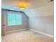 Cozy bedroom with plush carpeting, a large window, and neutral paint at 3600 Trail 23 St, Durham, NC 27707