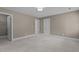 Carpeted bedroom with two doors, ceiling light, and neutral wall color at 3600 Trail 23 St, Durham, NC 27707