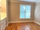 Bright bedroom with hardwood floors and a window with blinds at 3600 Trail 23 St, Durham, NC 27707