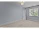 Cozy bedroom featuring carpet, light blue walls, and a window for natural light at 3600 Trail 23 St, Durham, NC 27707
