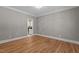 Neutral bedroom with hardwood floors and views into the kitchen at 3600 Trail 23 St, Durham, NC 27707