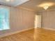 Spacious bedroom with gleaming hardwood floors, a crystal chandelier, and plenty of natural light at 3600 Trail 23 St, Durham, NC 27707