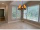 Sunlit breakfast nook with large windows offering serene views, and tiled floors at 3600 Trail 23 St, Durham, NC 27707